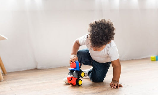 Boy plays with colorful toy truck for What’s so great about used toy trucks?