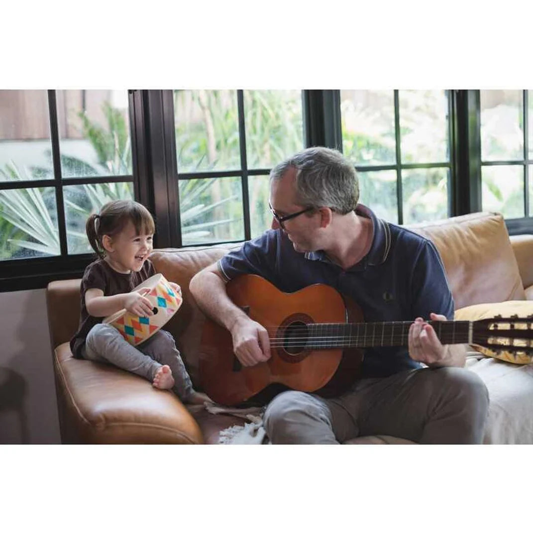 Dad and daughter play toy drums from PlanToys