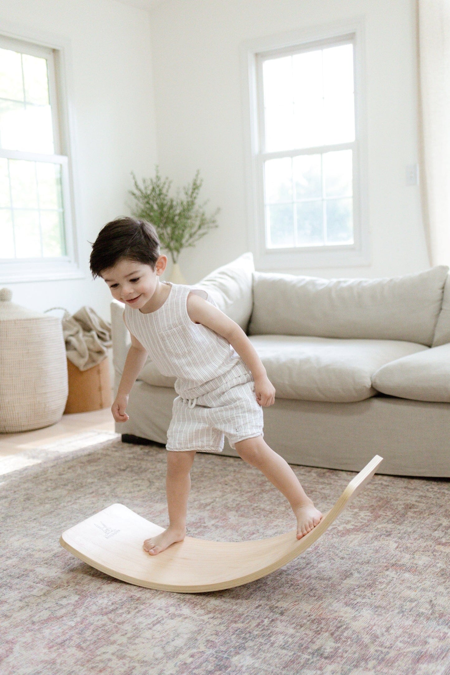 Montessori balance board child plays in living room