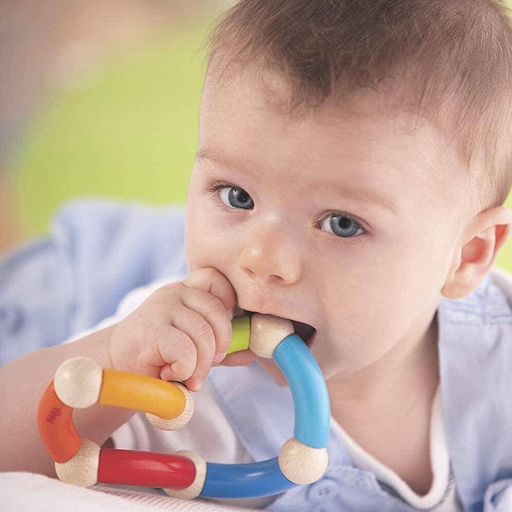 Baby chews on HABA Color Snake Wooden Rattle & Fidget Toy Wooden Baby