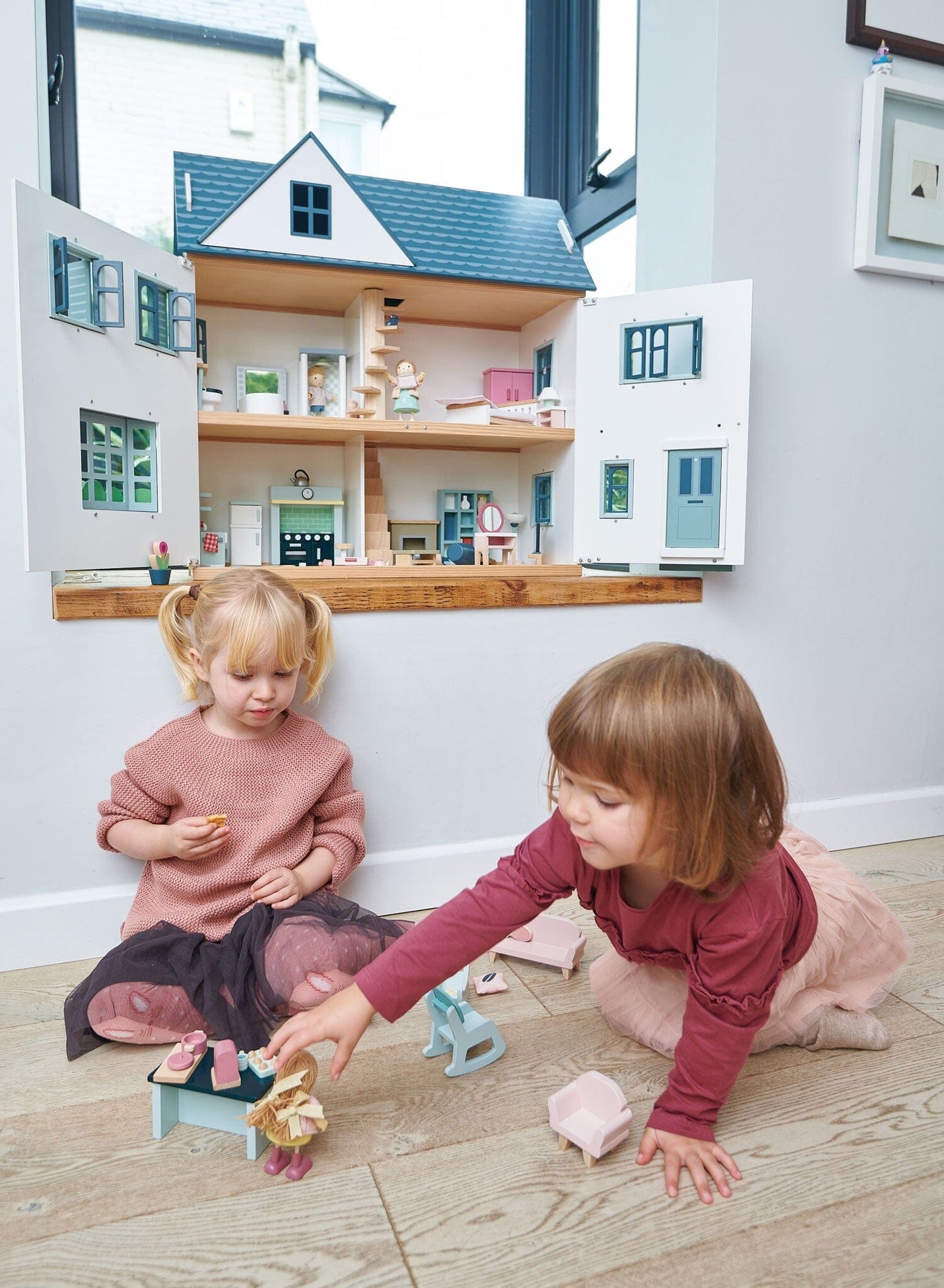 2 kids play with Tender Leaf Dollhouse Dovetail House