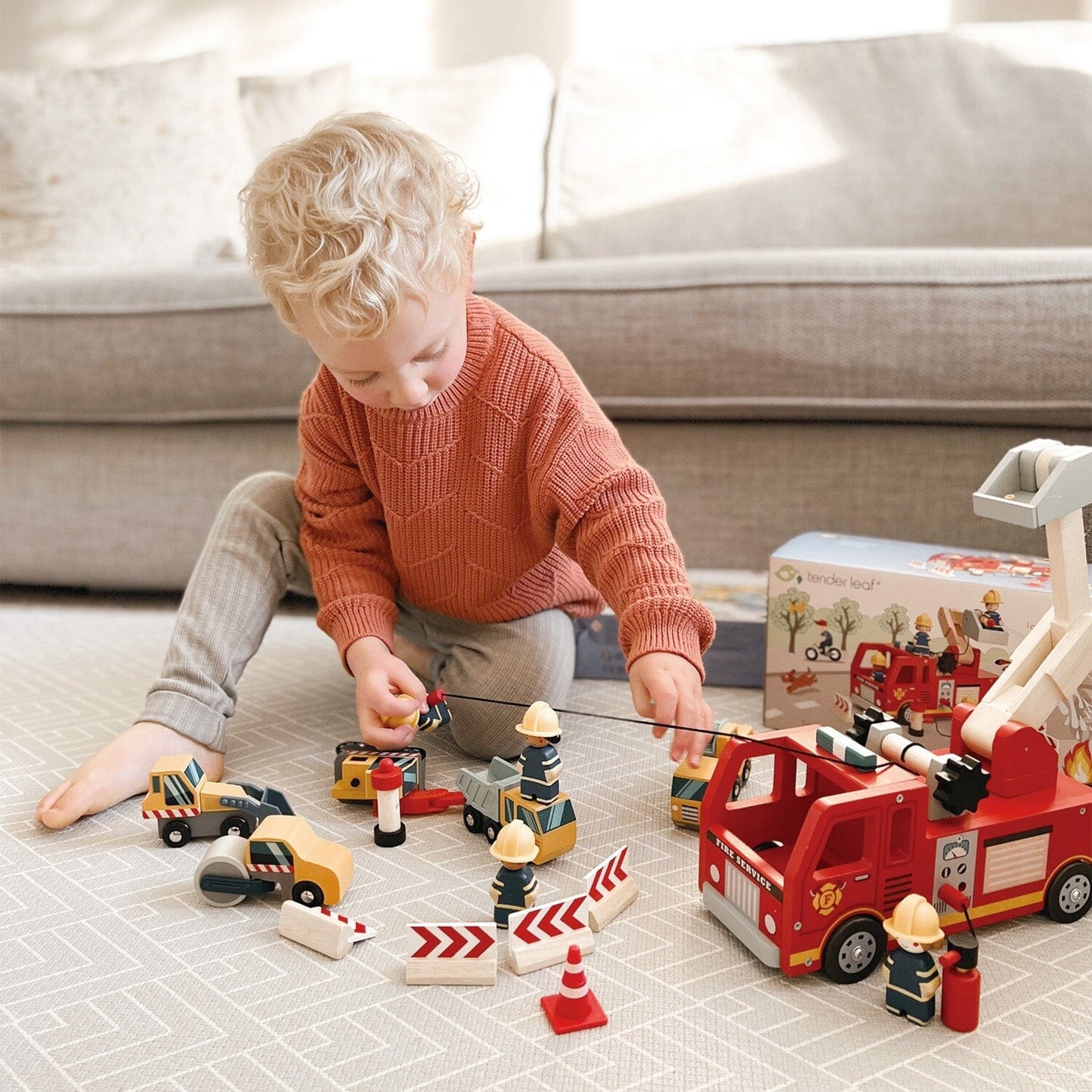 Child plays with Wood Toy Fire Engine