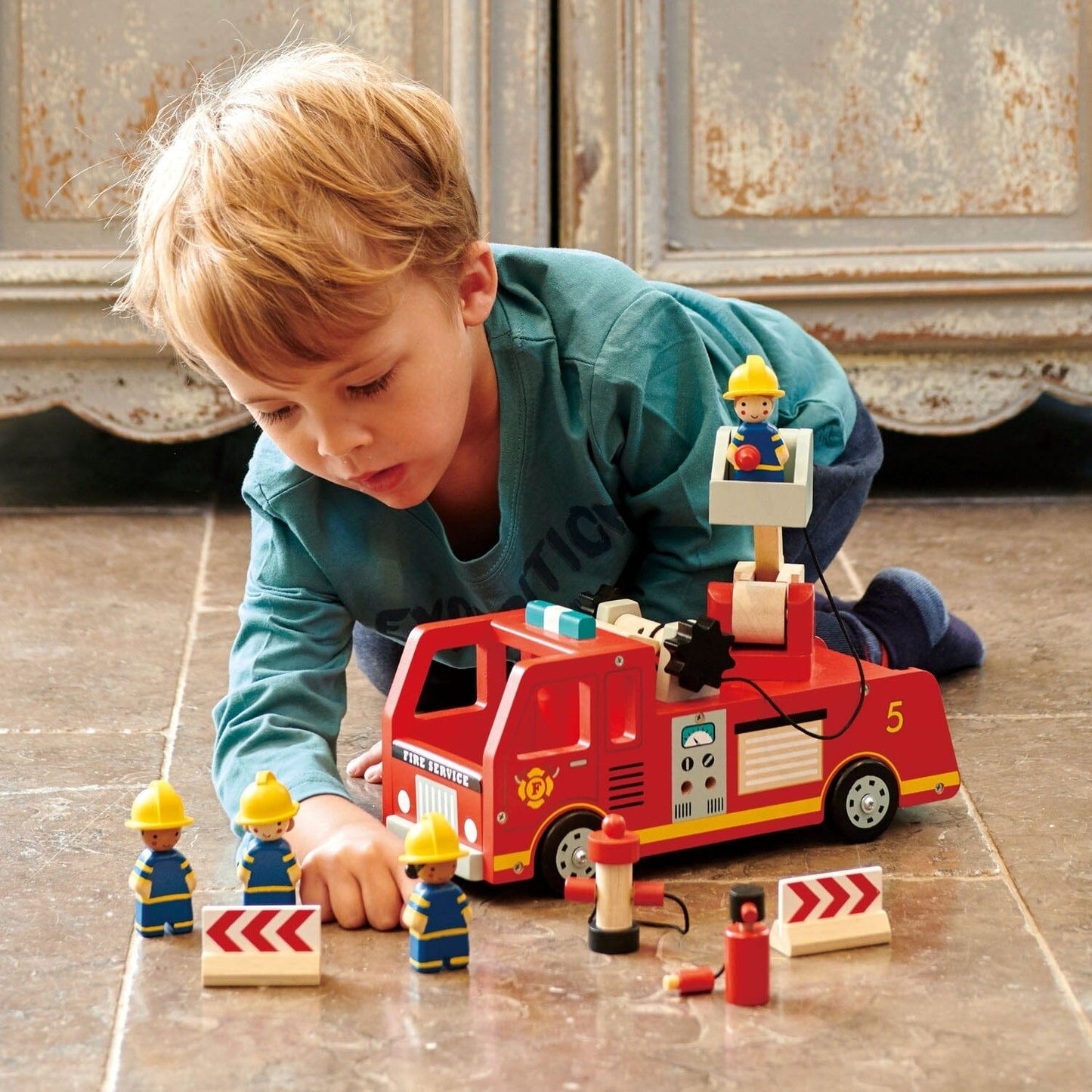 Child plays with Wood Toy Fire Engine