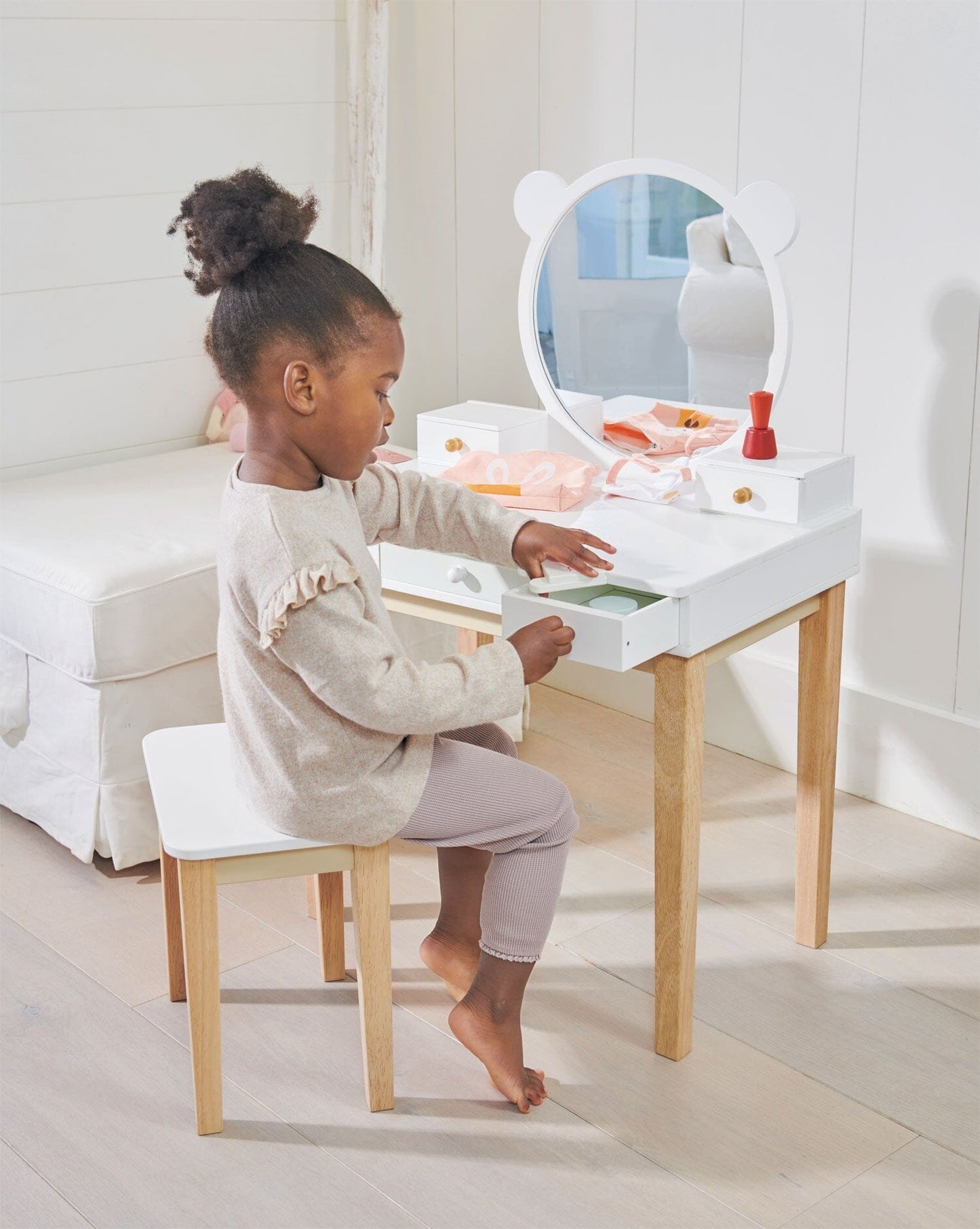 Child sits in front of Childs Dressing Table Set from Tender Leaf