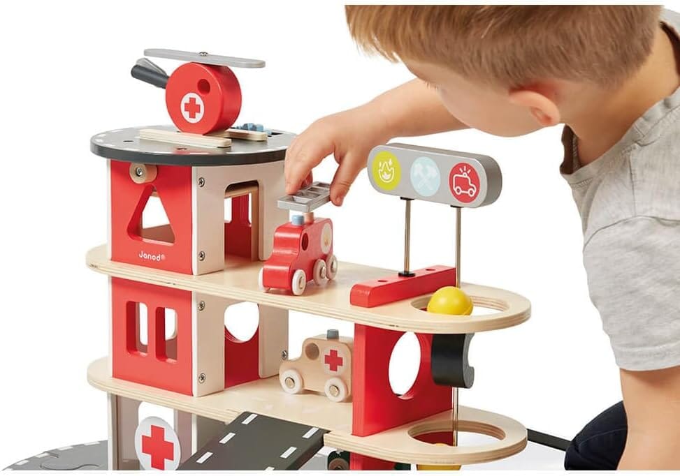 Child plays with helicopter from Janod Wooden Toy Fire Station