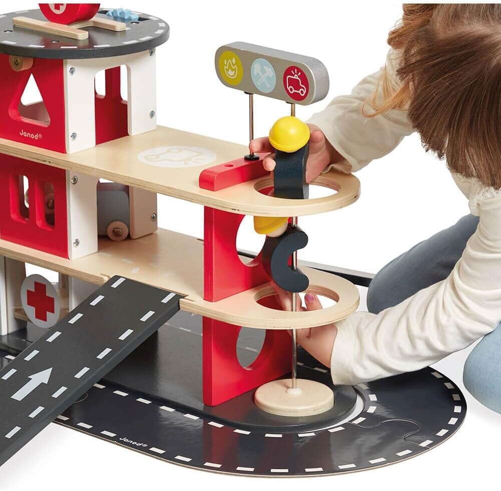 Child plays with Janod Wooden Toy Fire Station