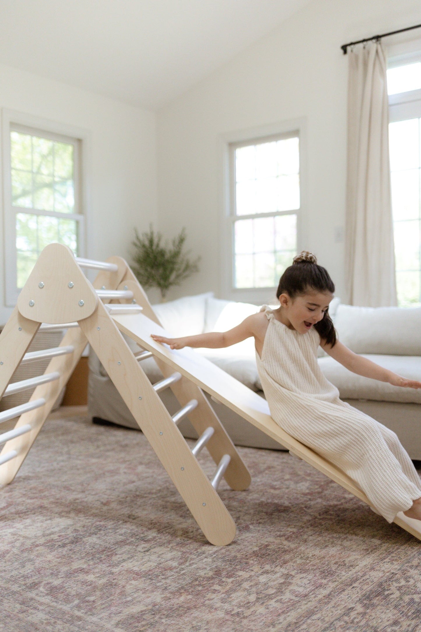 Child plays on Bunny Hopkins Pikler Climbing Triangle Set
