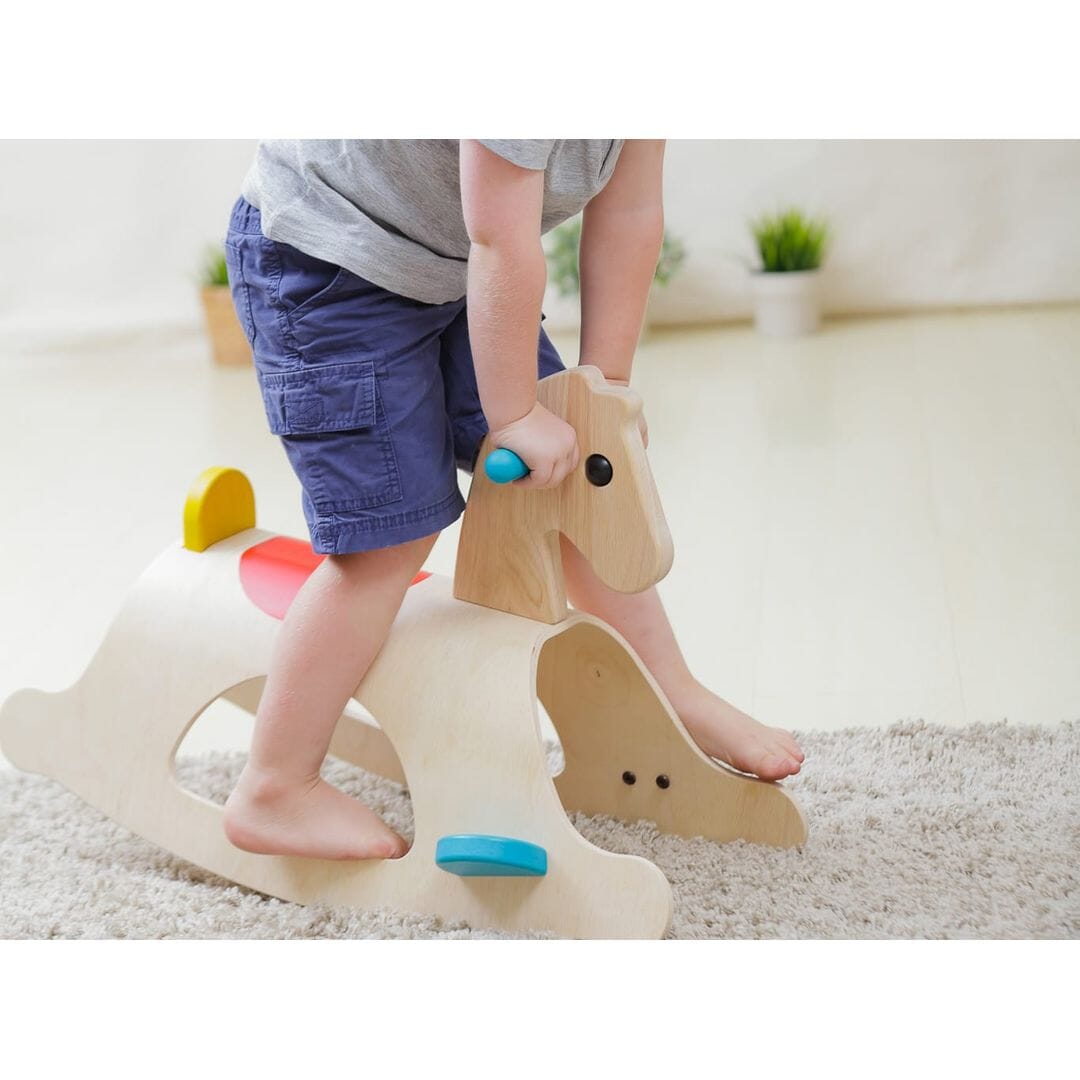 Child rides on PlanToys Palomino Wood Toy Horse
