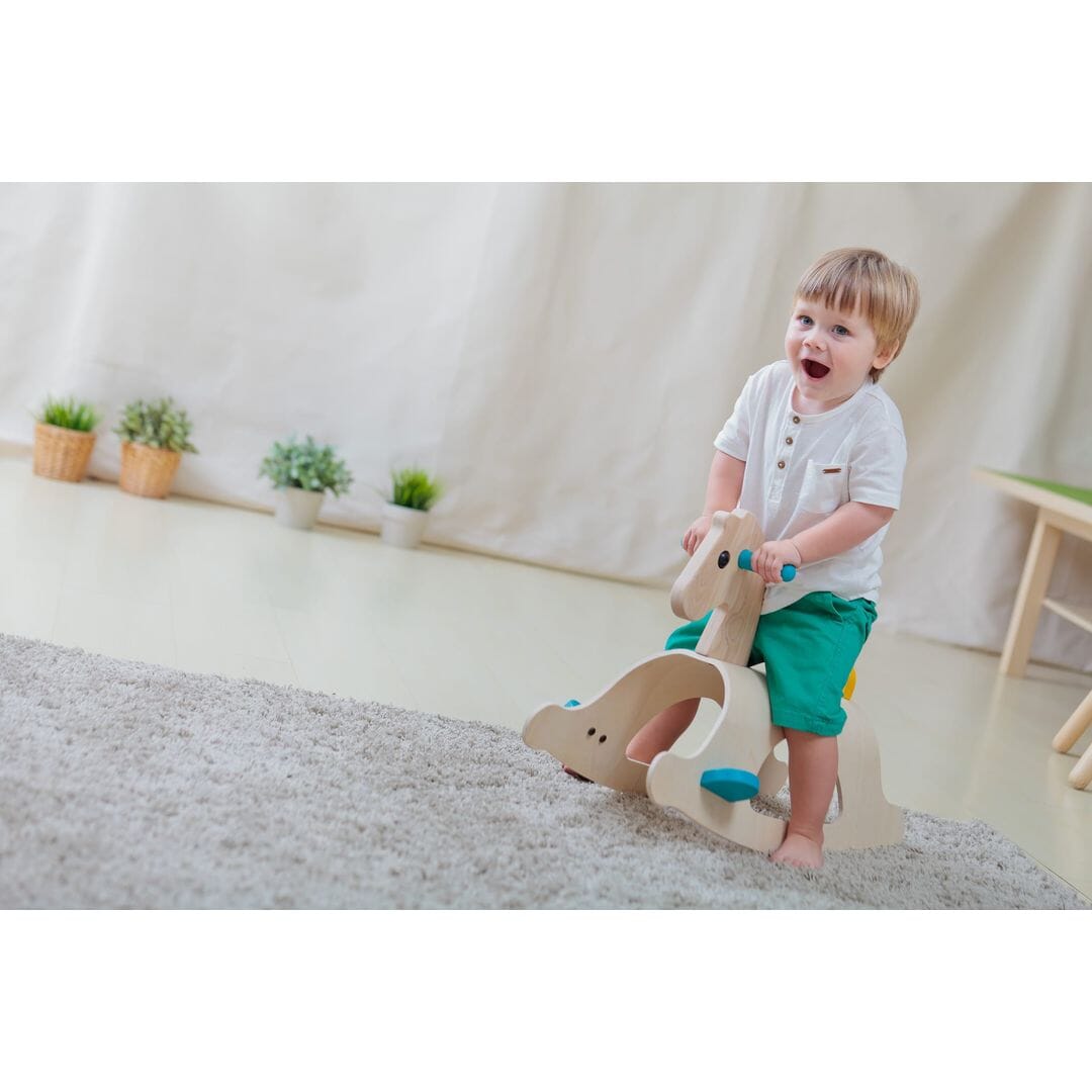 Child on PlanToys Palomino Wood Toy Horse Ride-on
