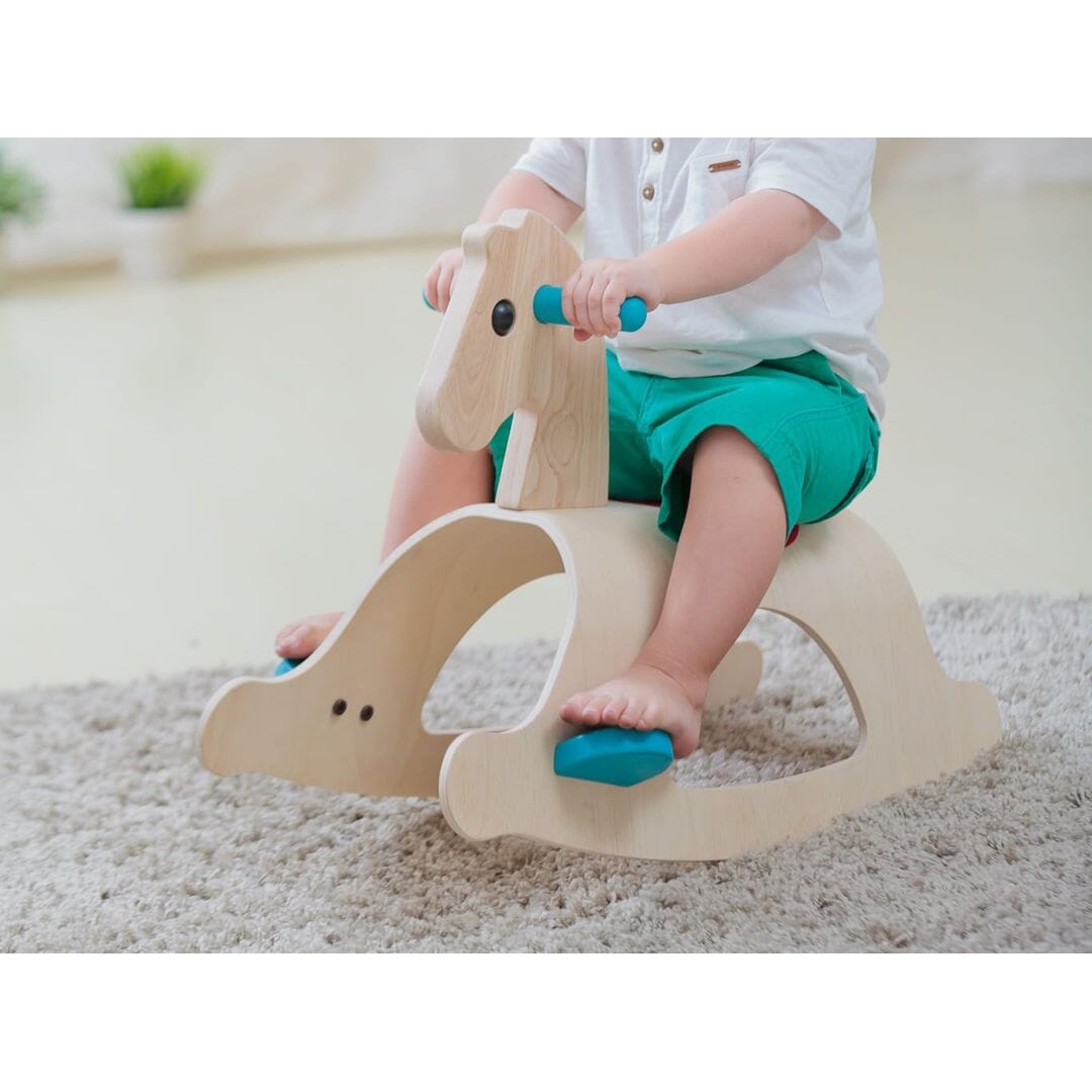 Child on PlanToys Palomino Wood Toy Horse Ride-on