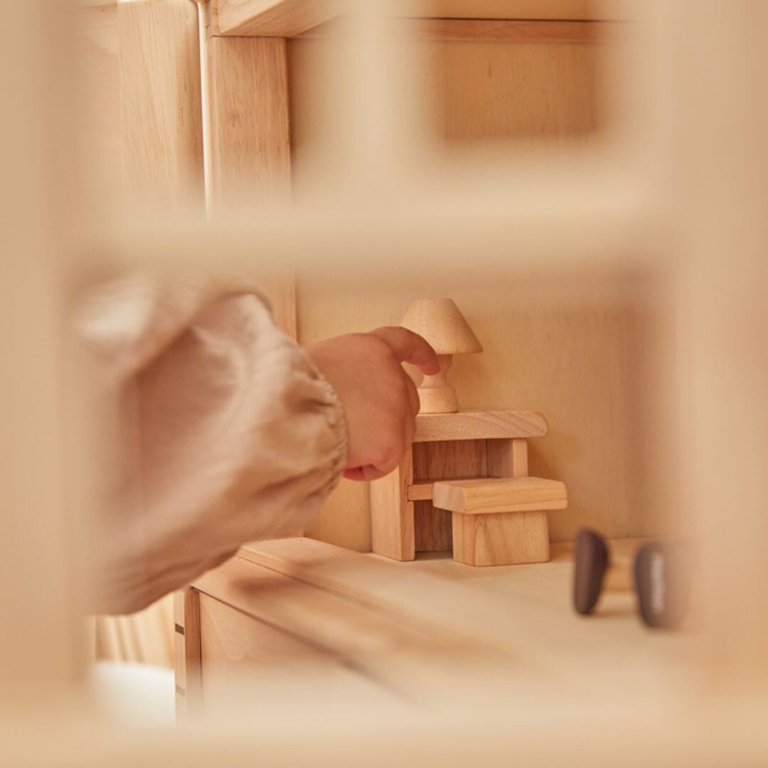 Extreme close up inside PlanToys Victorian Dollhouse natural wooden dollhouse with 3 stories including attic - natural finish.