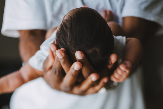 Baby Items You Should Buy Used Dad cradles baby's head in hands