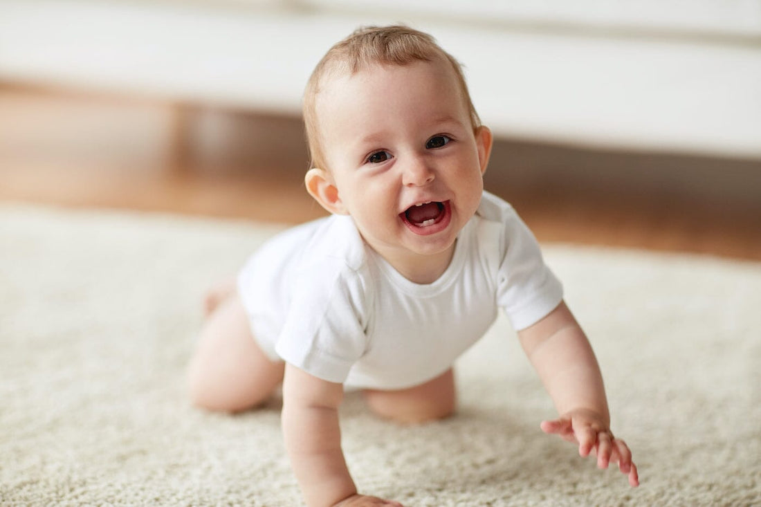Smiling baby learning to crawl how to support crawling
