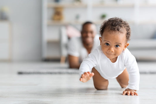 Smiling baby learning to crawl how to support crawling