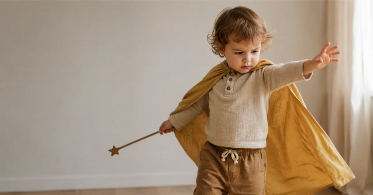 Toddler in colorful dress-up costume, deeply absorbed in pretend play with focused expression