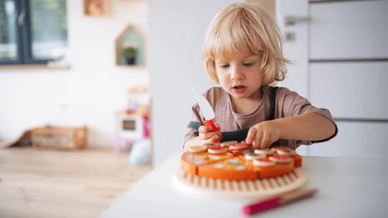 Boy playing with pretend play food toys - quality used toys from Toycycle