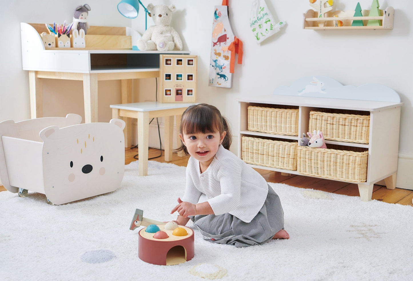 child plays in front of Tender Leaf Bunny Storage Unit for play room or bedroom