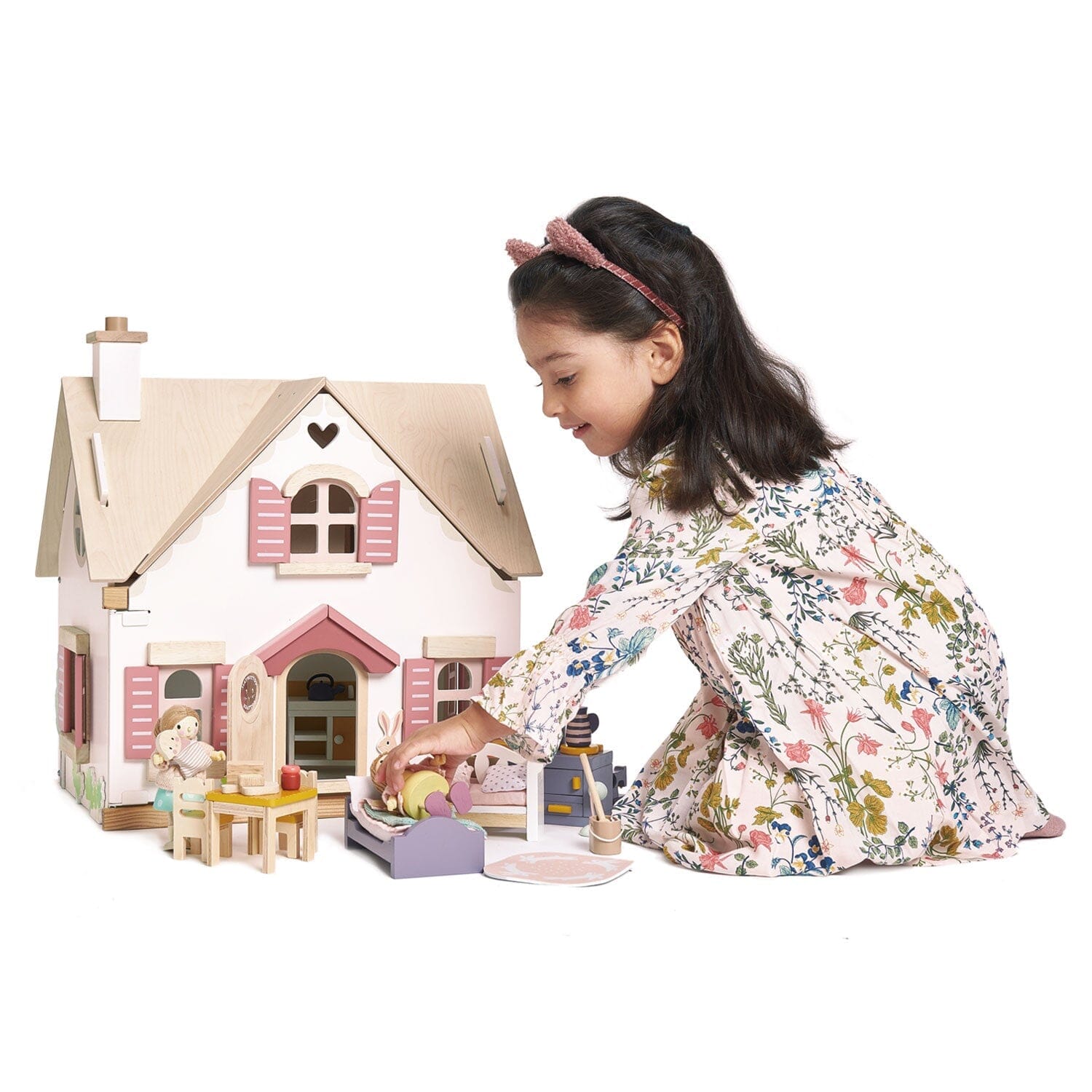 Child plays with Tender Leaf Cottontail Cottage and furniture