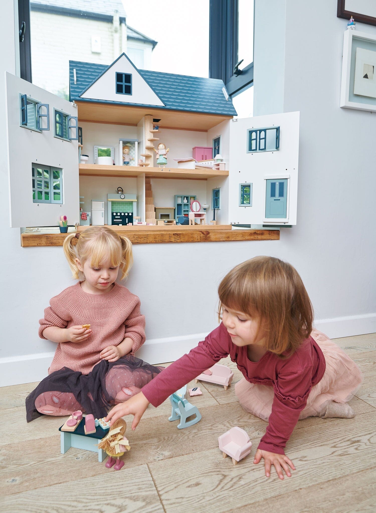 2 kids play with Tender Leaf Dollhouse Dovetail House 