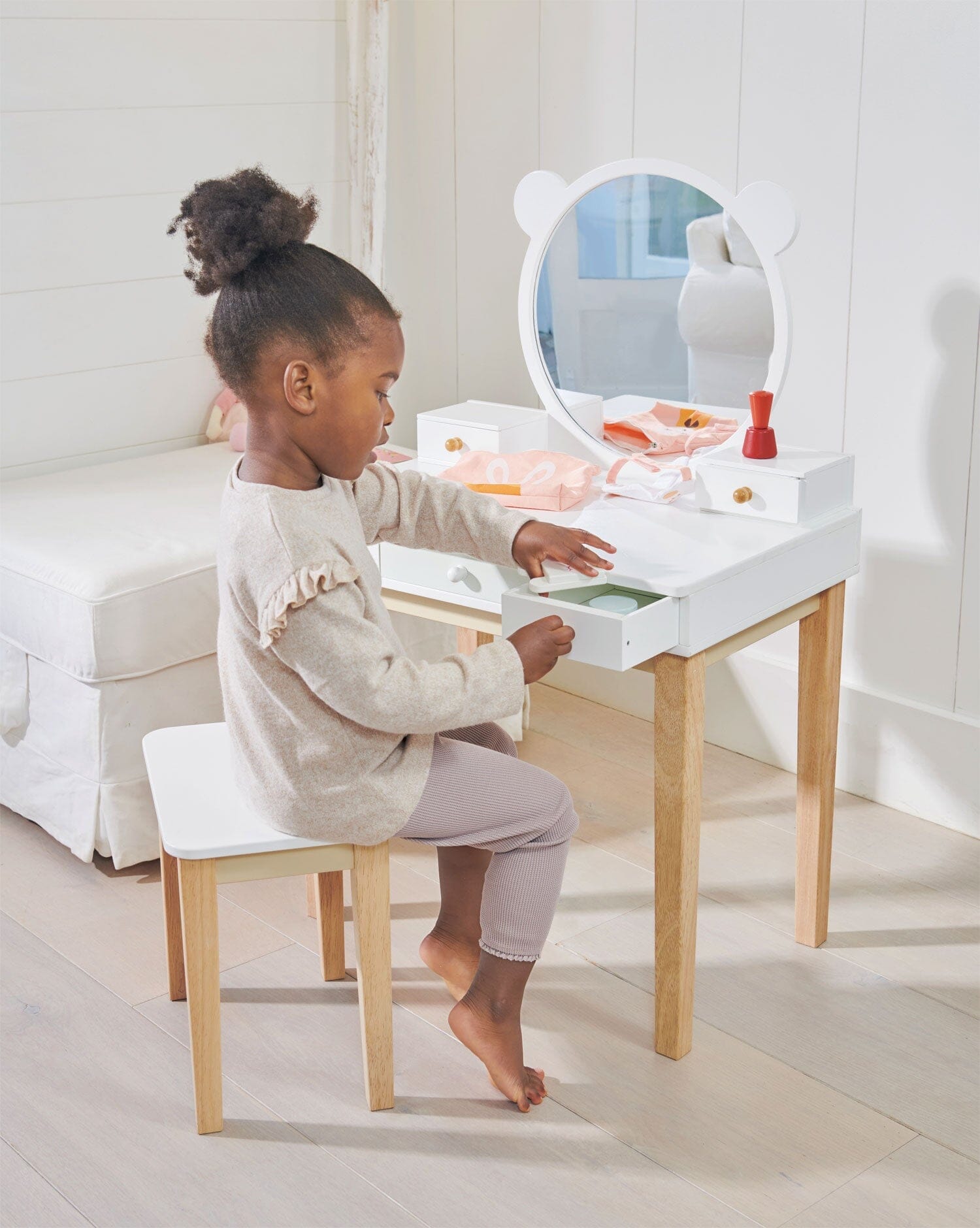 Child sits in front of Childs Dressing Table Set from Tender Leaf