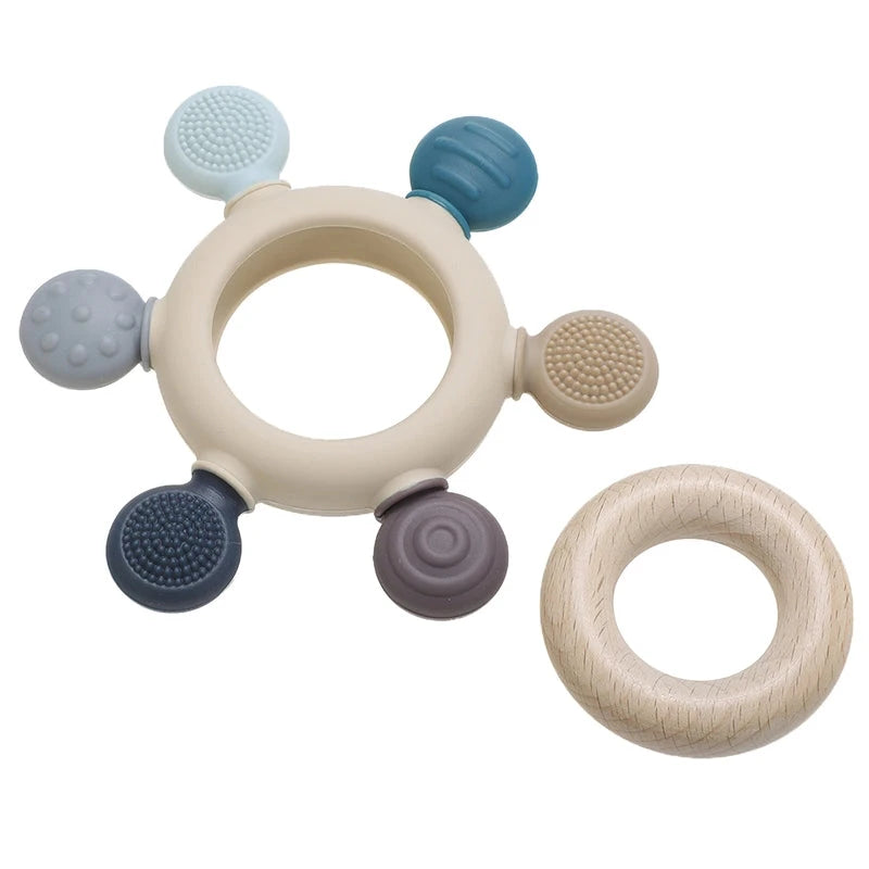 Infant teething toy with textured silicone and removable wooden ring.