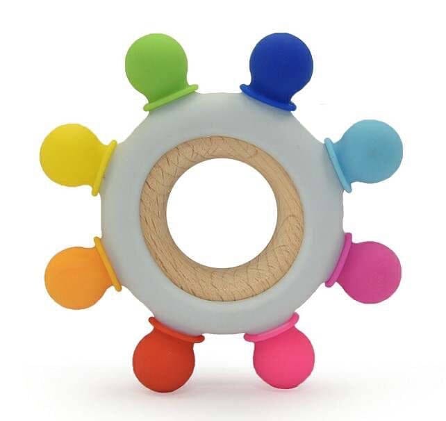 Infant teething toy with textured silicone knobs in rainbow colors.