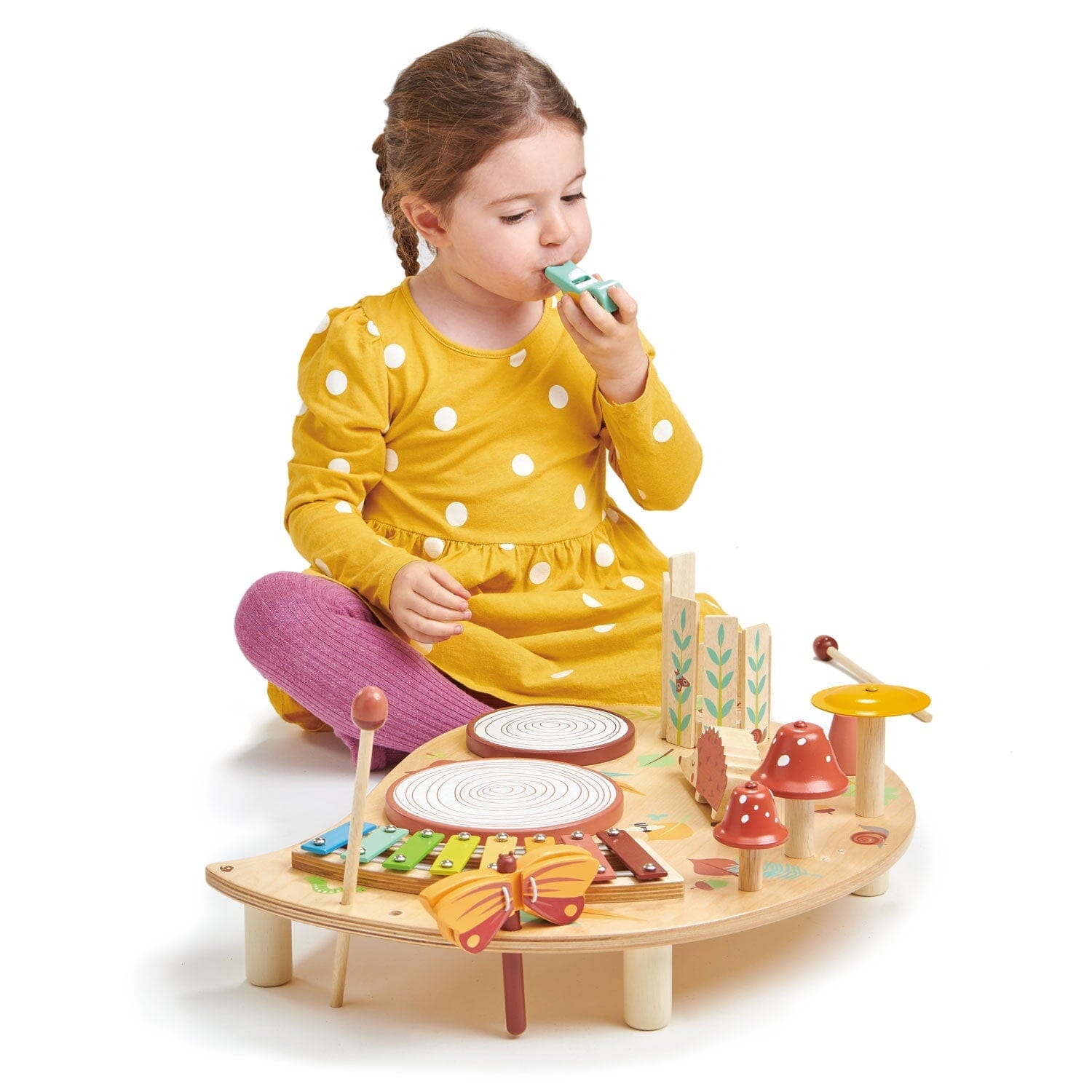 Child blows whistle from TenderLleaf Toys Musical Table
