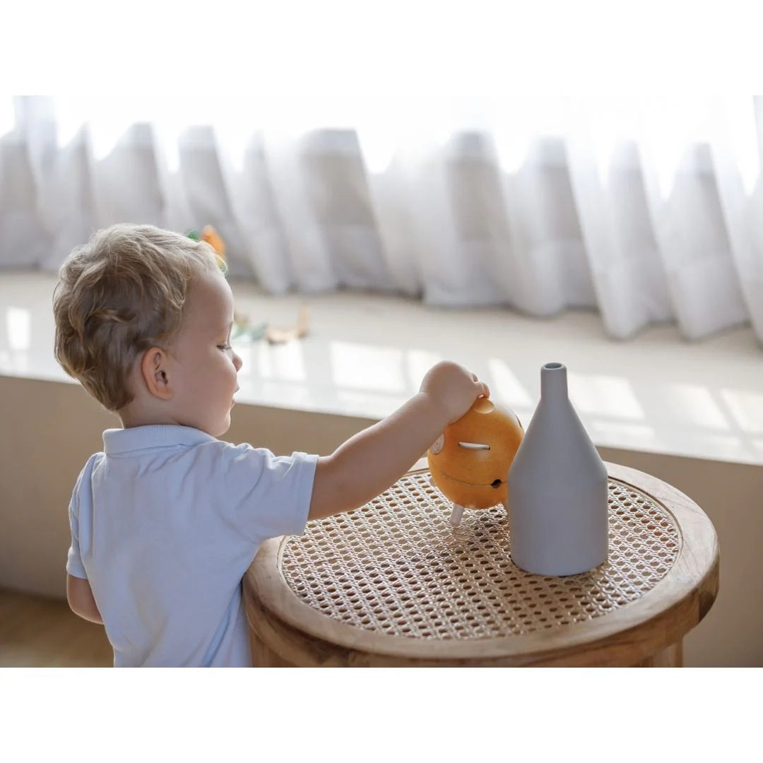 Child uses PlanToys Piggy Bank