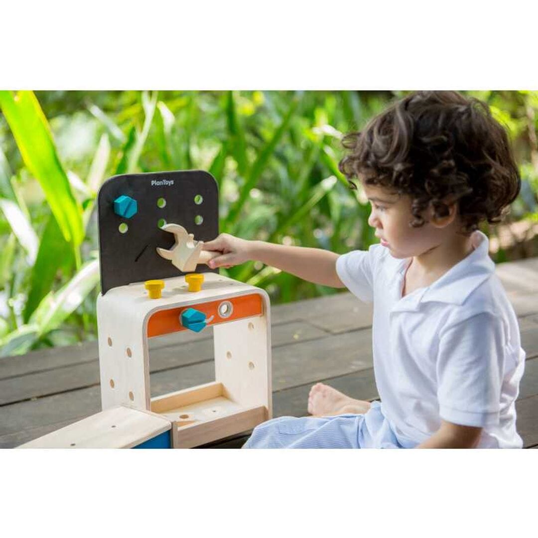 Child playing with  Childrens toy work bench from PlanToys