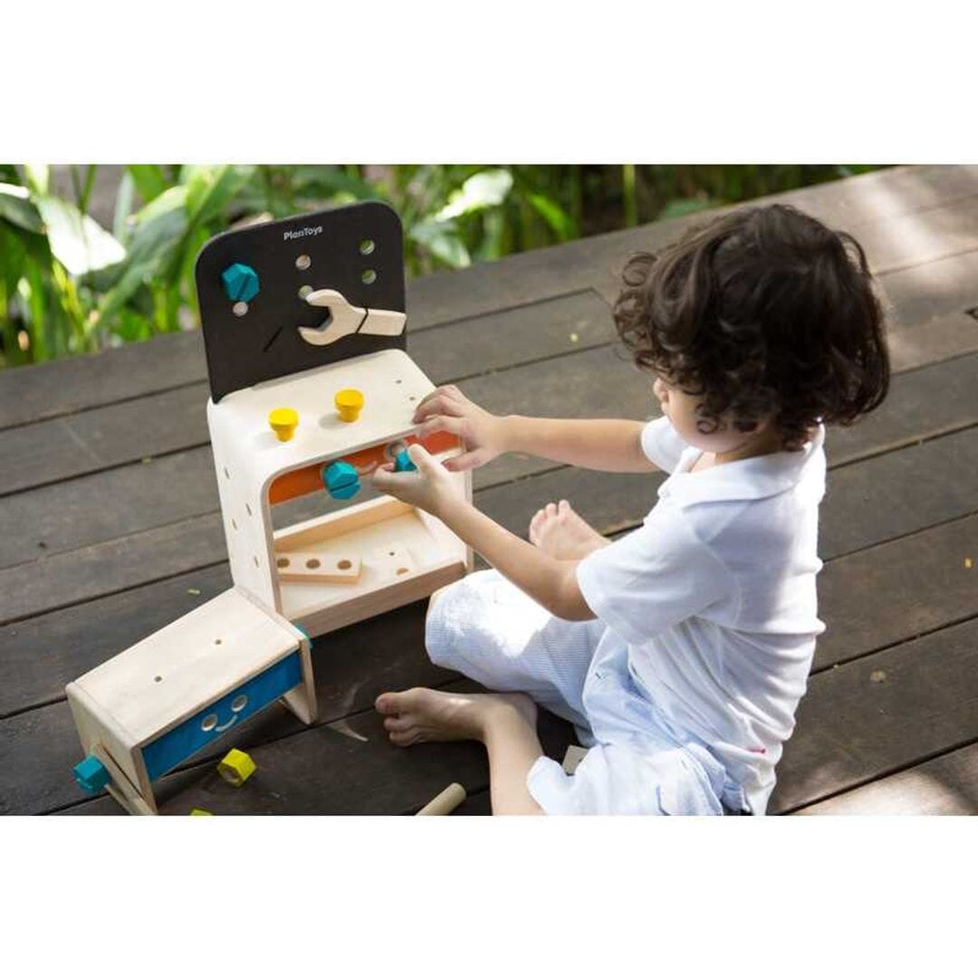 Child playing with Childrens toy work bench from PlanToys