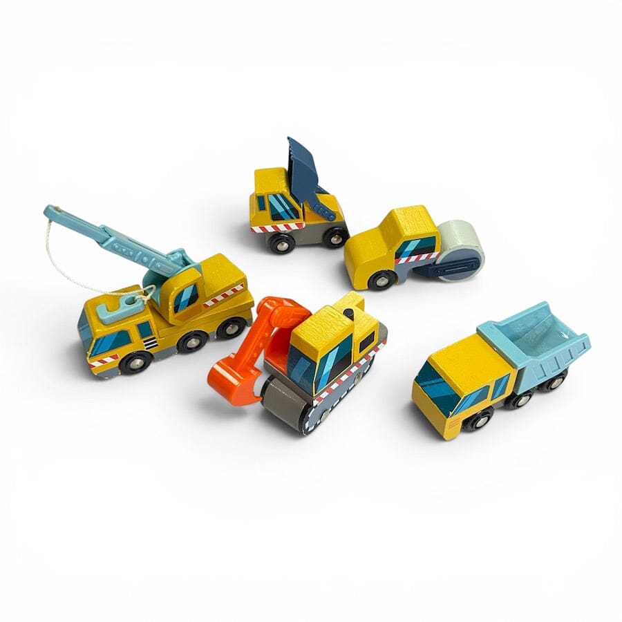 A set of 5 Tender Leaf Wooden Construction Vehicles in yellow and blue including a dump truck, front loader, excavation digger, crane truck, road roller against a white background.