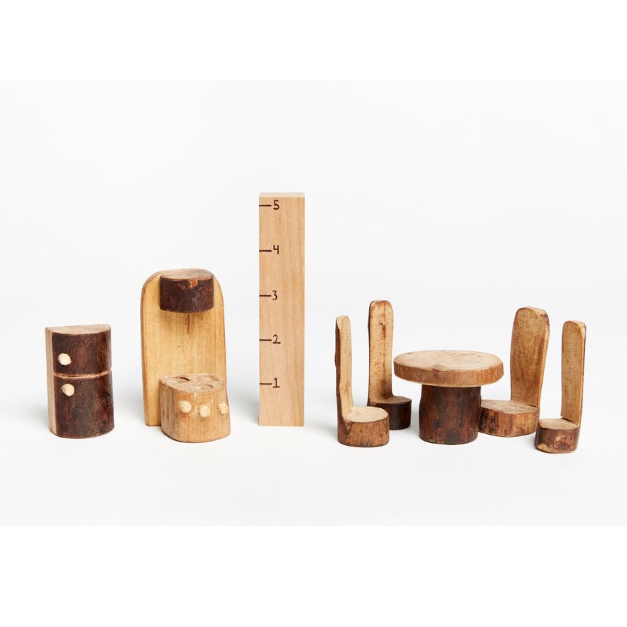 A set of Tree Blocks hand-carved wooden miniature furniture pieces, including a round kitchen table, four chairs, and two stools, displayed with a ruler for scale on a clean white background.