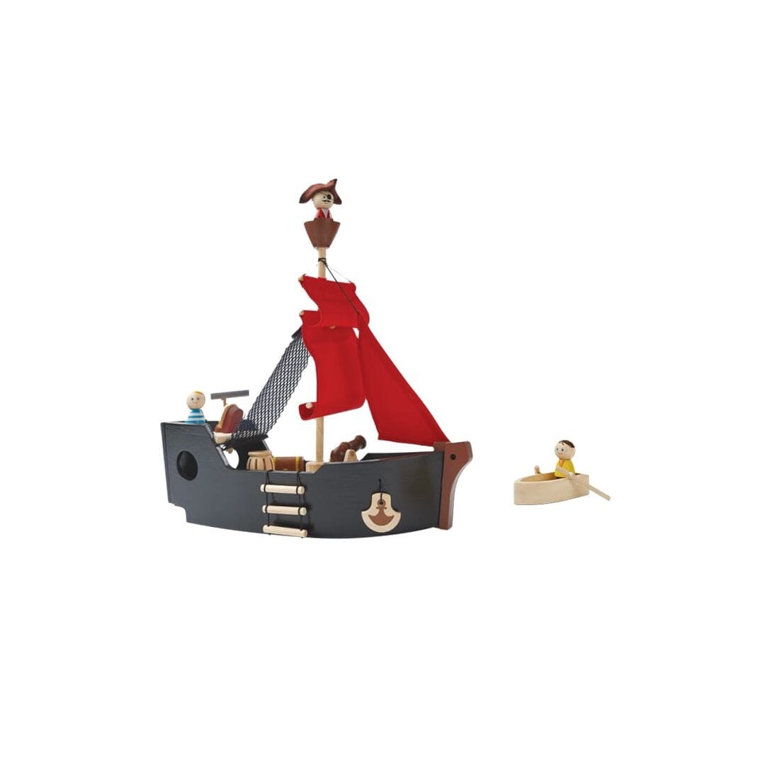 PlanToys wooden Pirate Ship black boat with red sail and wooden pirate figures, one pirate in the wooden row boat.