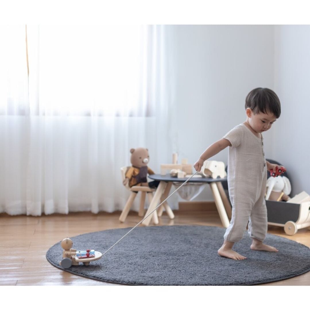 Toddler pulls PlanToys Pull Along Musical Bear