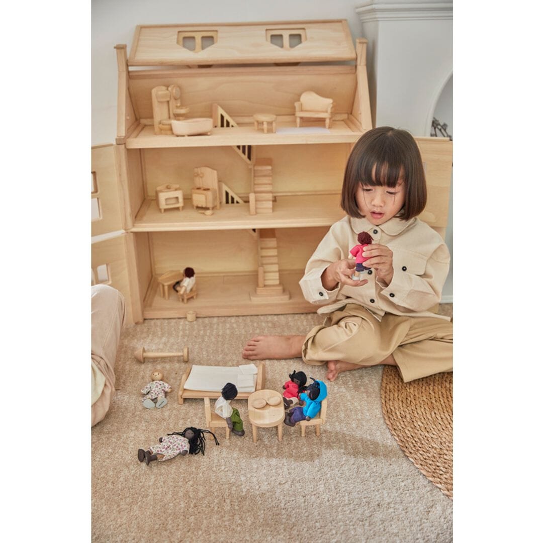 Child plays with PlanToys Victorian furniture set all natural wood unpainted for PlanToys Victorian dollhouse.